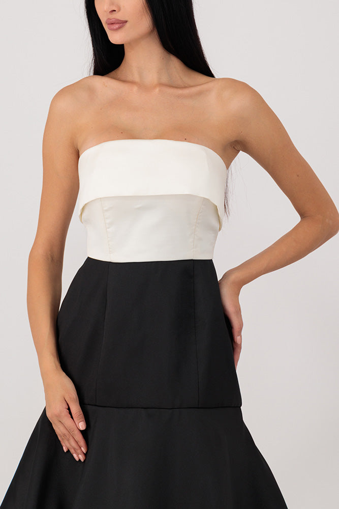 A white top dress with black layers.