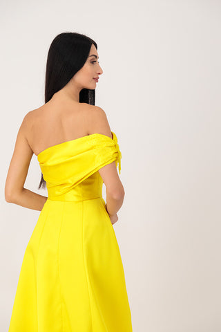 A yellow corset dress with embroidery on the sleeves.