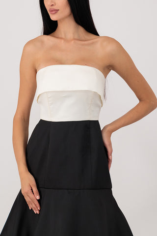 A white top dress with black layers.